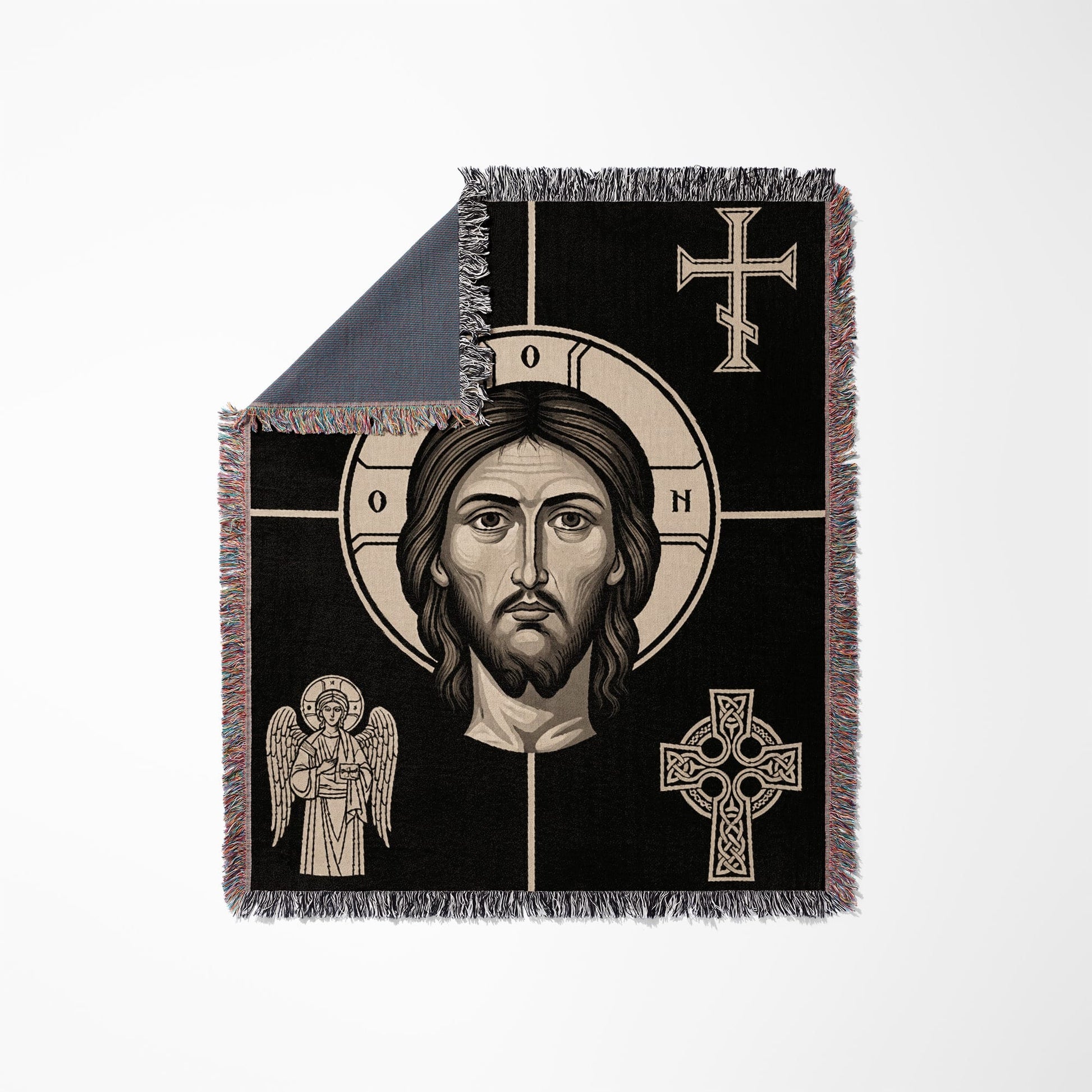 Icon of Jesus' face on a black woven blanket with fringe.