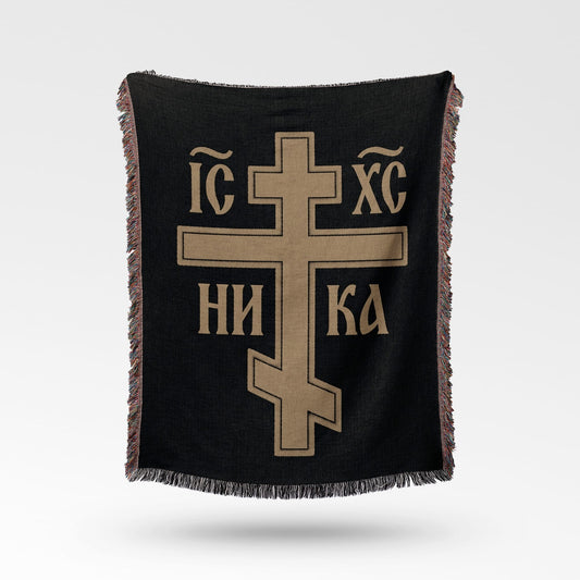 Black woven throw blanket with a gold Byzantine cross and text.