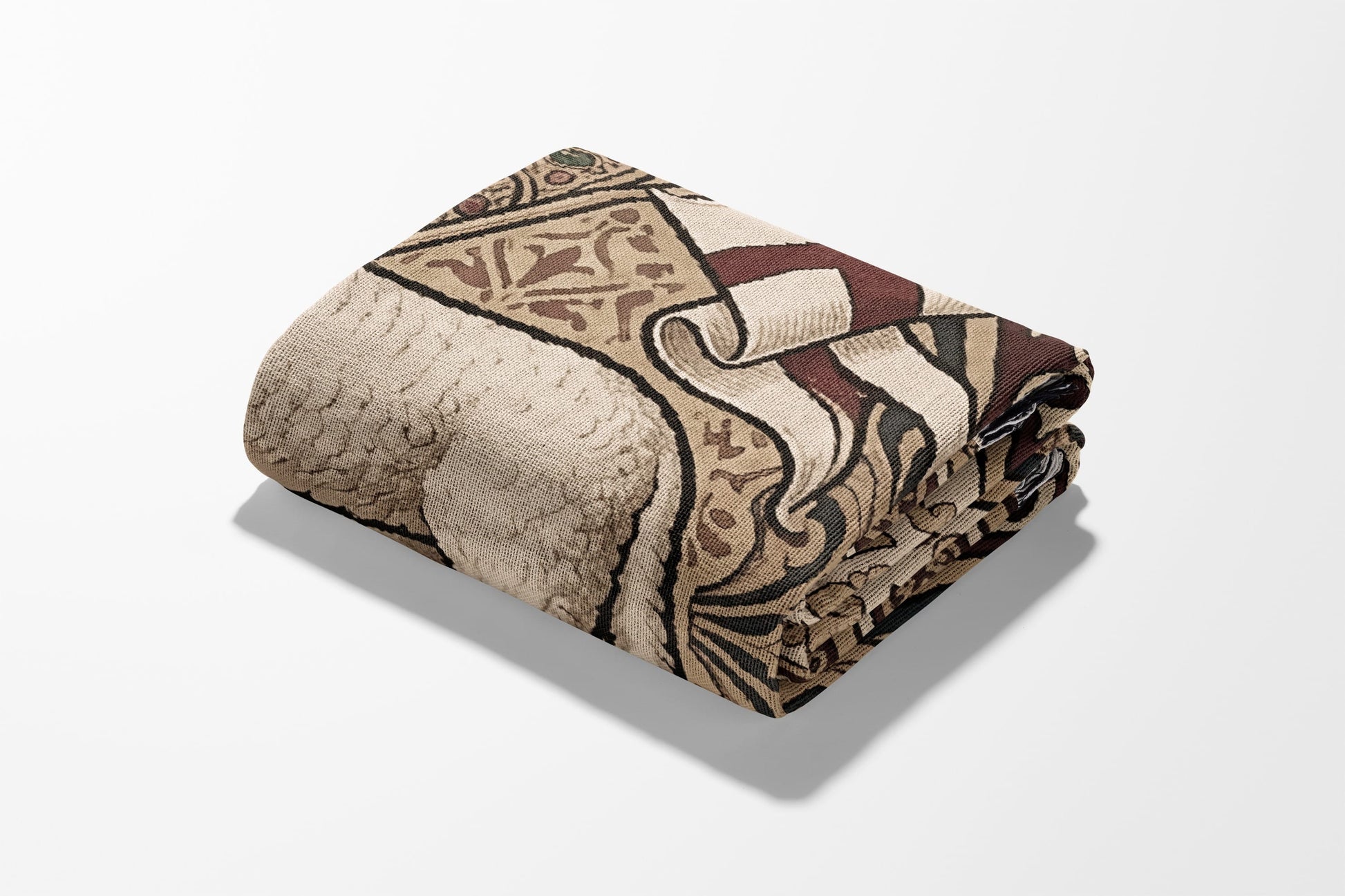 Folded beige and brown patterned blanket with a shadow.