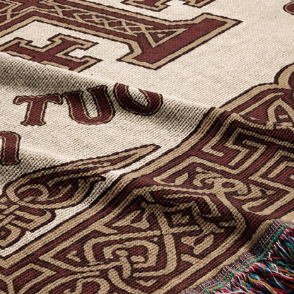 Tapestry throw with tan and brown knotwork and text "TUO".
