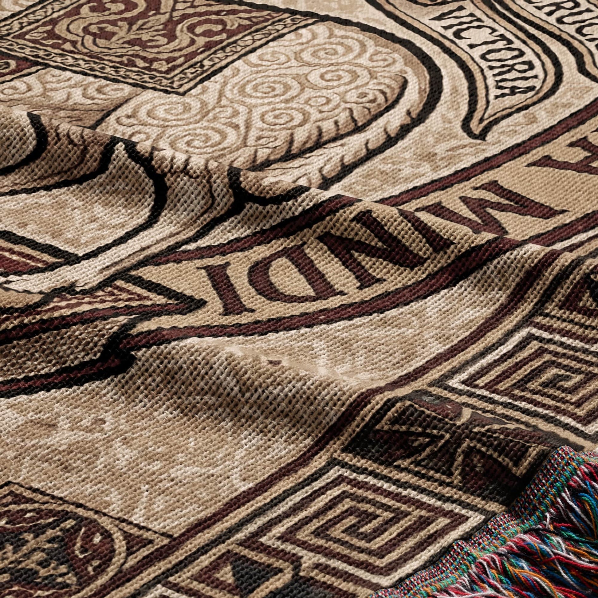 Brown blanket with intricate patterns and text "VICTORIA".