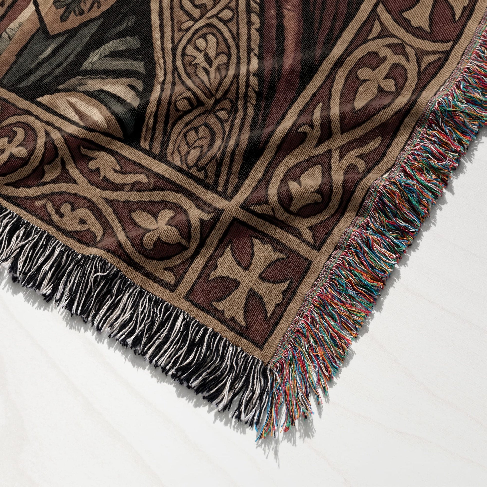 Brown woven throw blanket with ornate geometric pattern and tasseled fringe.