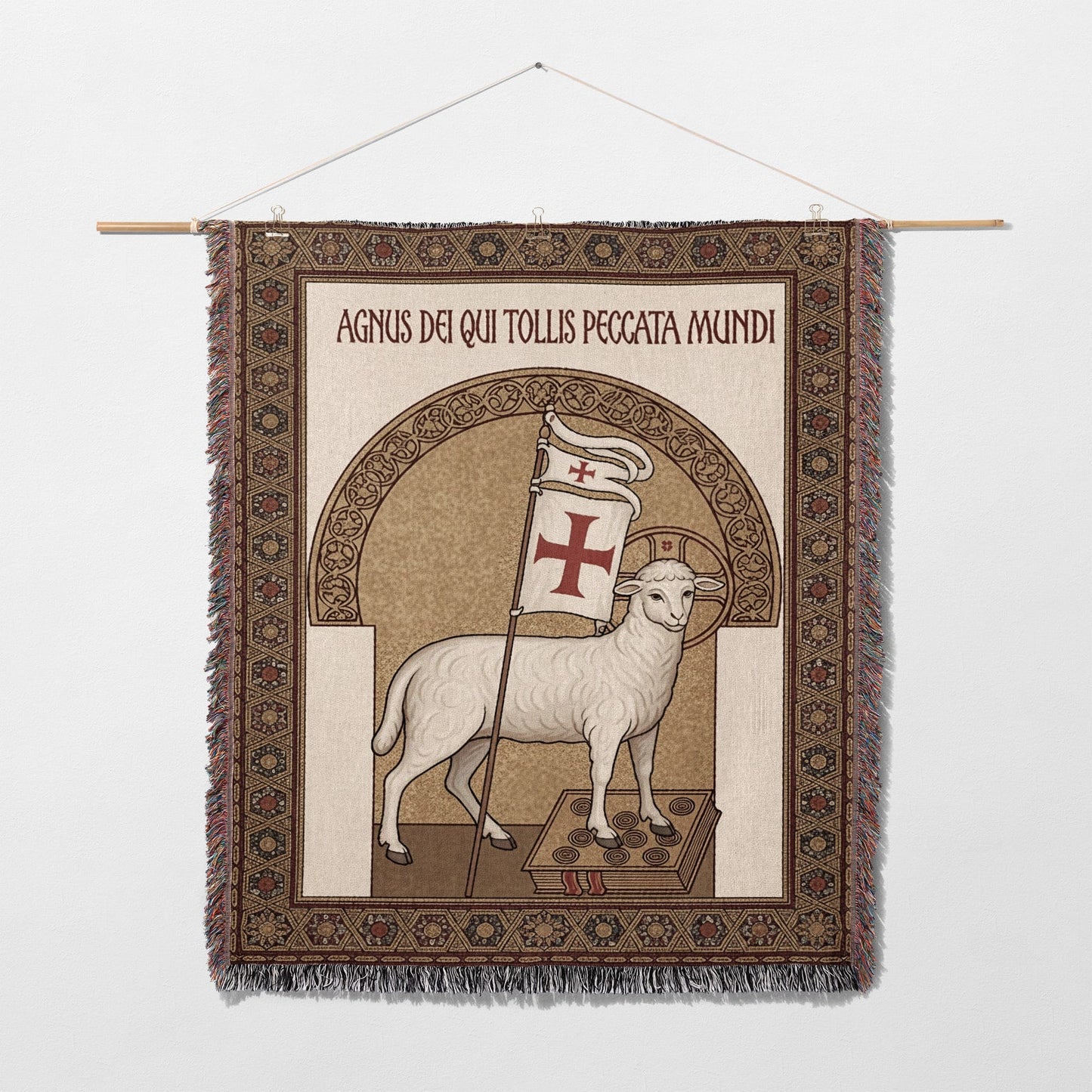 Tapestry of a lamb with a cross banner, bearing Latin text.