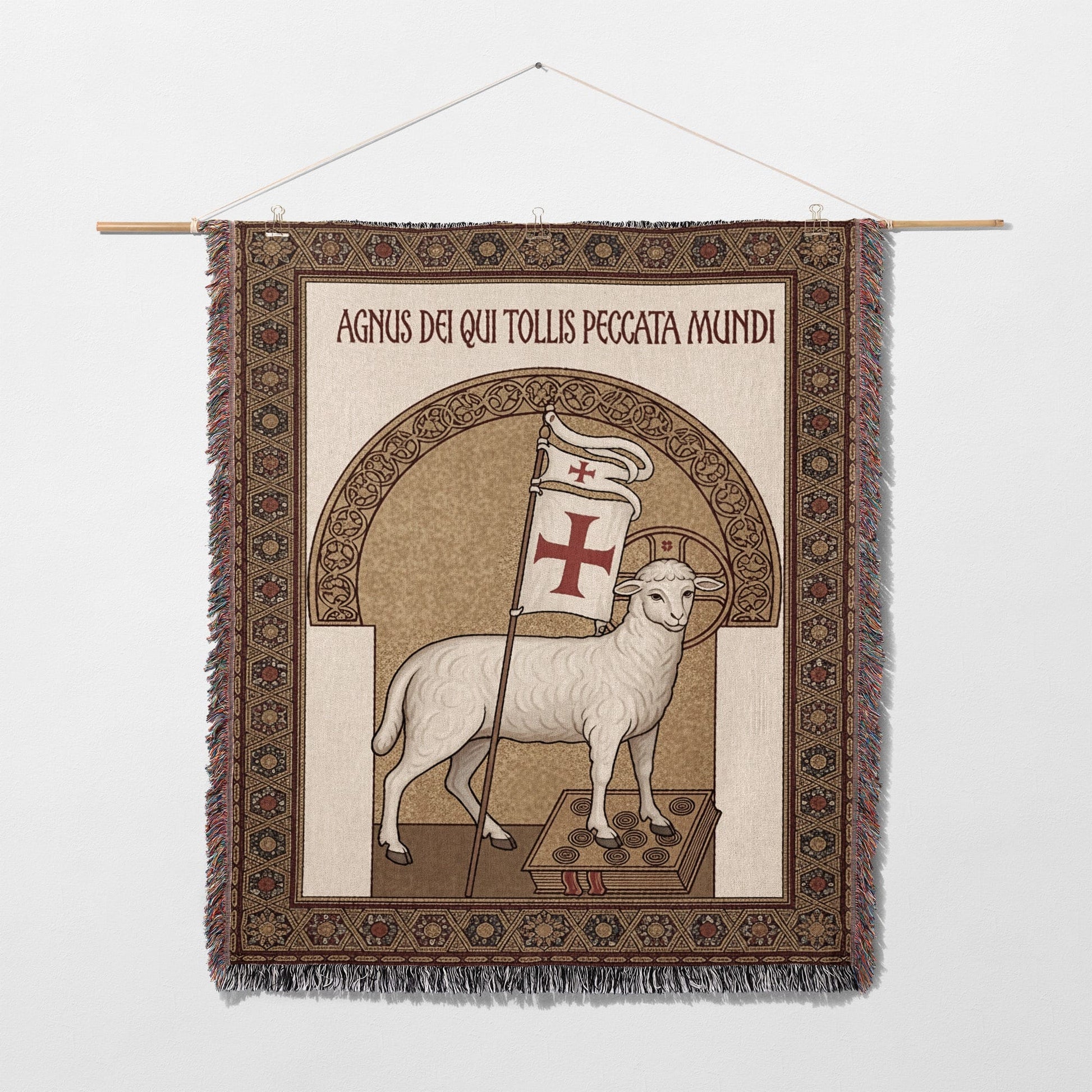 Tapestry of a lamb with a cross banner, bearing Latin text.