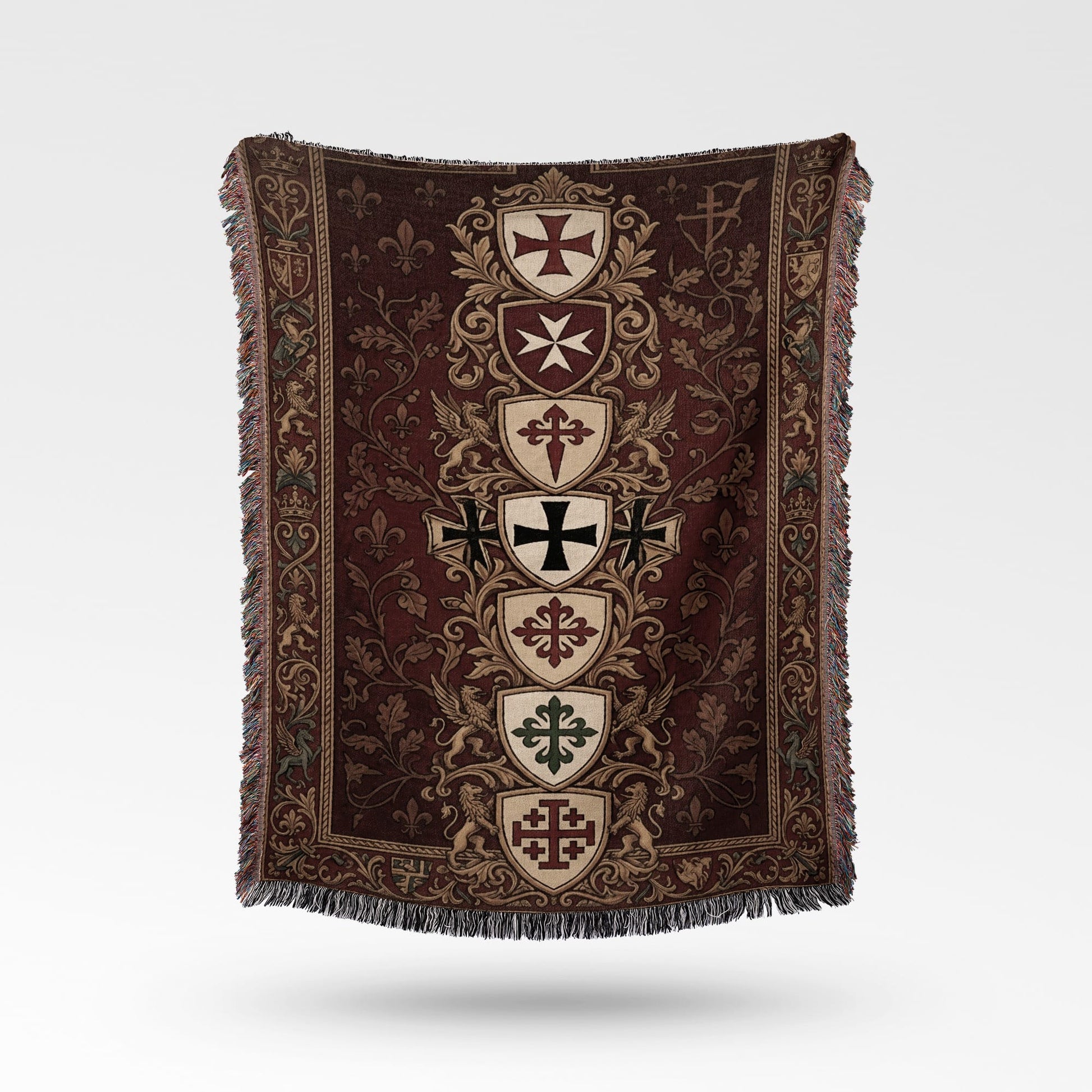 Tapestry throw with medieval crests, fleur-de-lis, and griffins on maroon background.