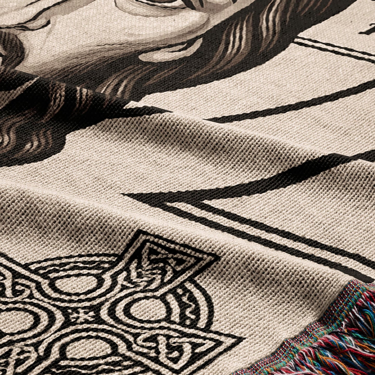 Woven blanket with Celtic knot designs and a partial portrait.