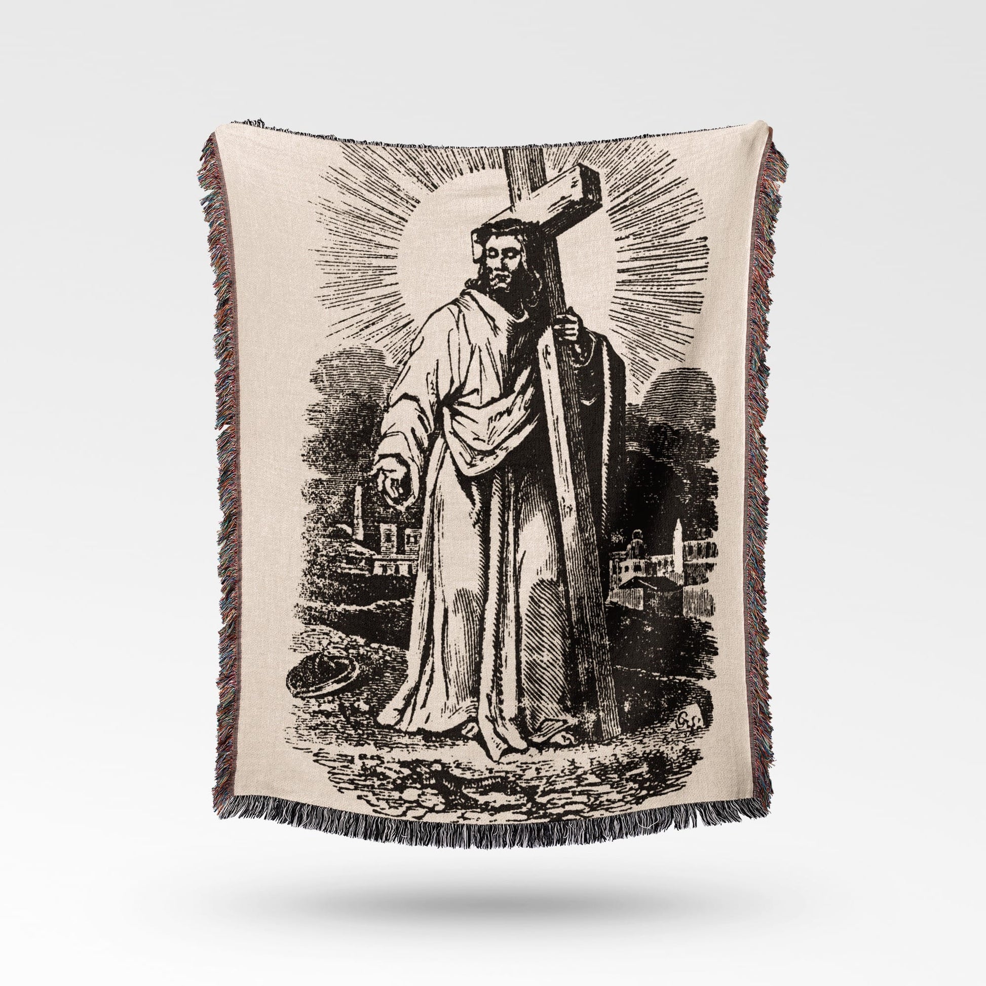 Jesus Christ carrying the cross on a textured, fringed throw blanket.