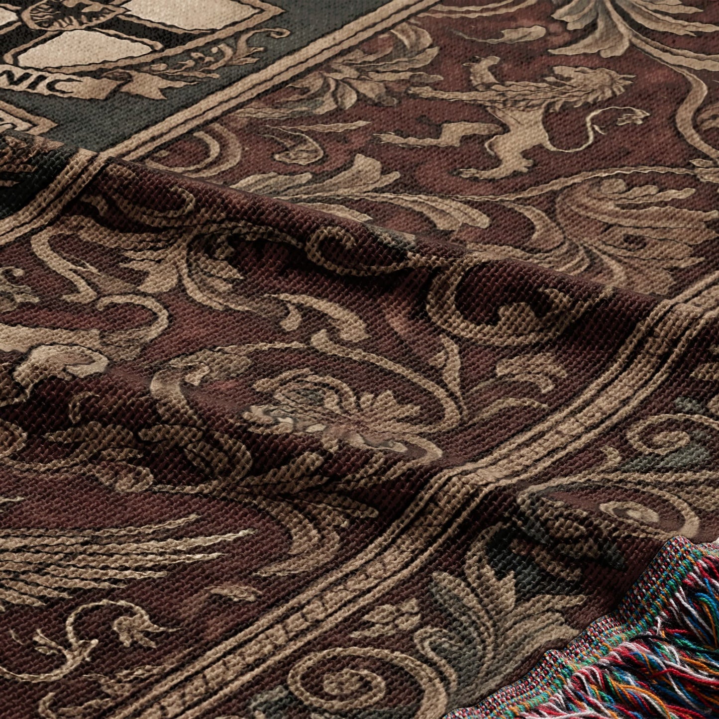 Tapestry blanket with ornate scrolling pattern and lions, with colorful fringe.