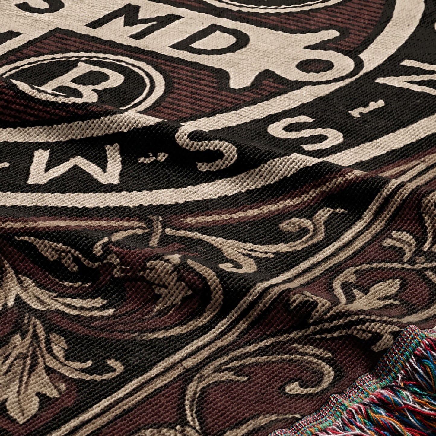Woven throw blanket with intricate pattern and fringed edge.