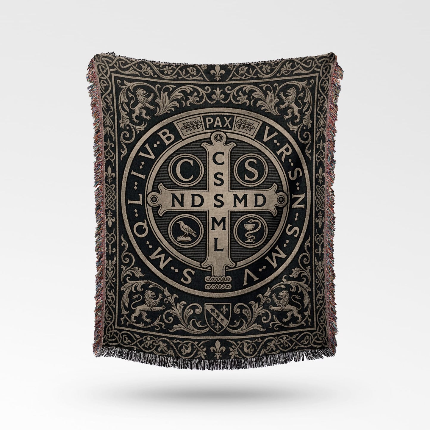 Woven blanket with St. Benedict medal design and ornate border.