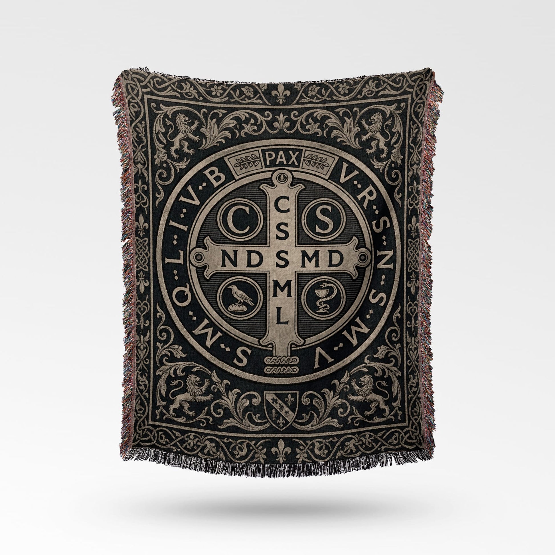 Woven blanket with St. Benedict medal design and ornate border.