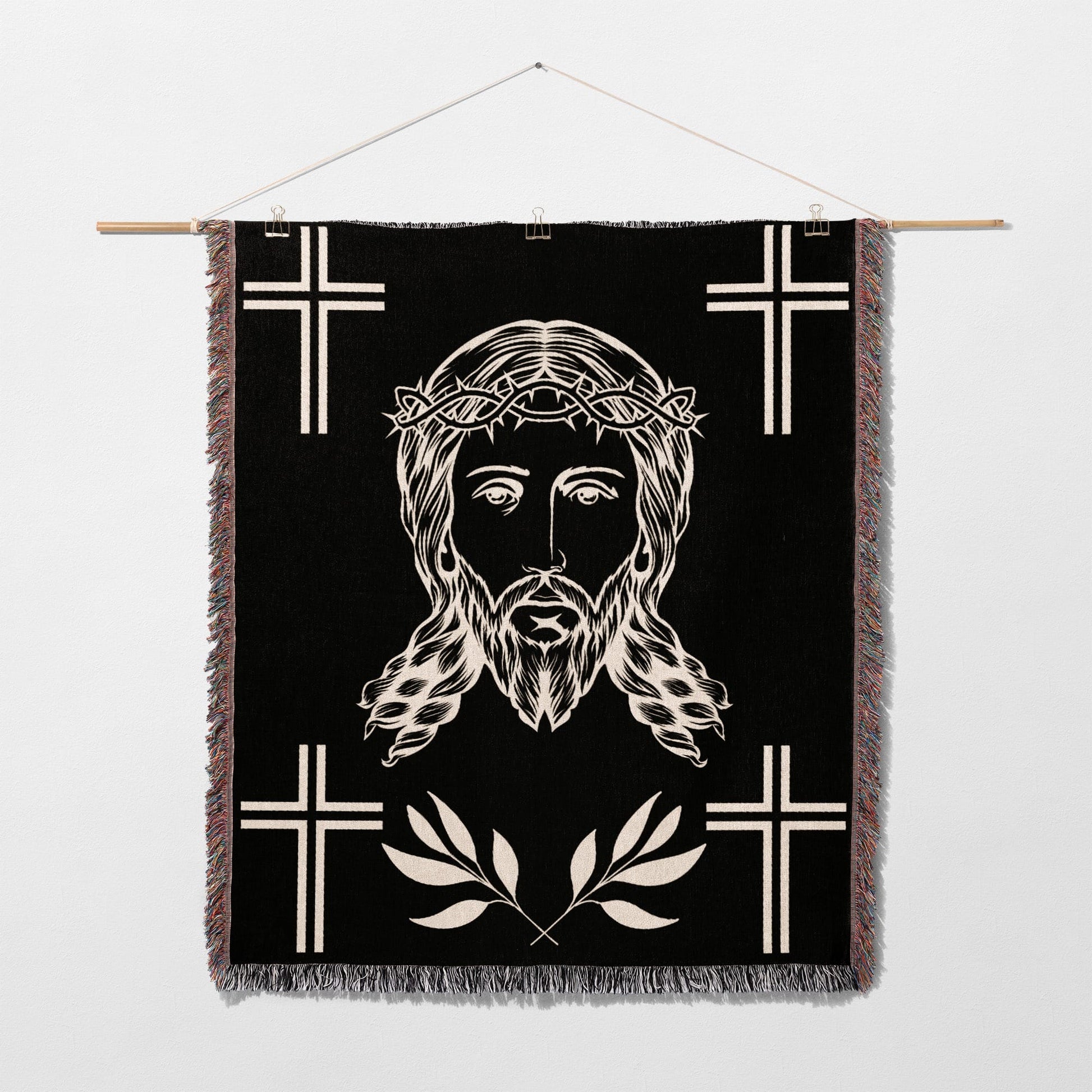 Black woven tapestry with Jesus' face, thorns, and crosses.