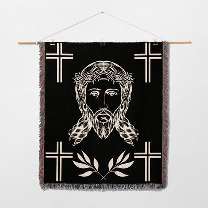 Black woven tapestry with Jesus' face, thorns, and crosses.
