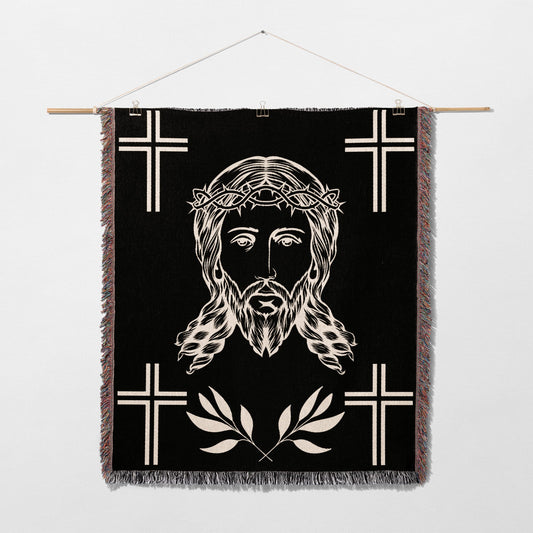 Black woven tapestry with Jesus' face, thorns, and crosses.