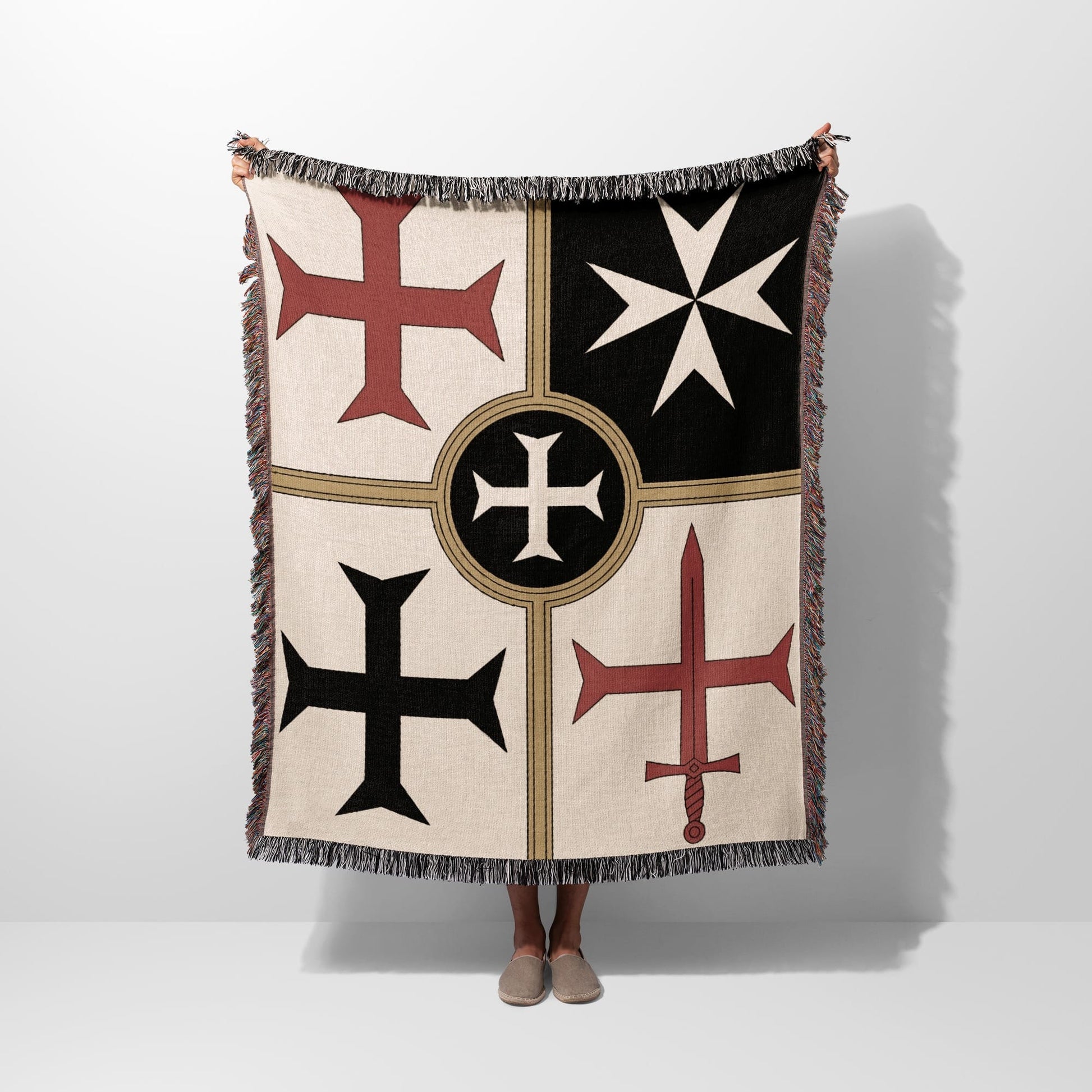 Beige throw blanket with Templar cross designs and fringe.