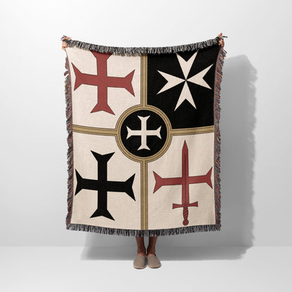 Beige throw blanket with Templar cross designs and fringe.