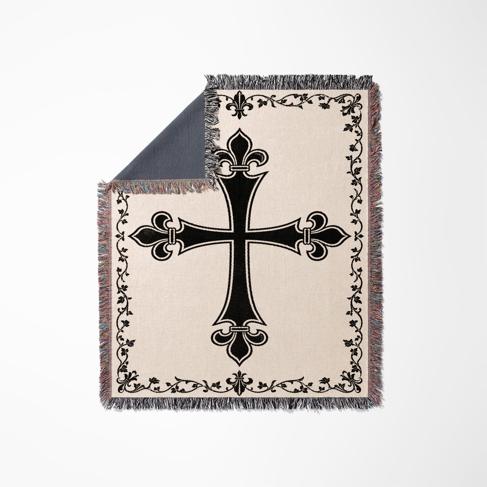 Cream blanket with black gothic cross pattern and fringed edges.