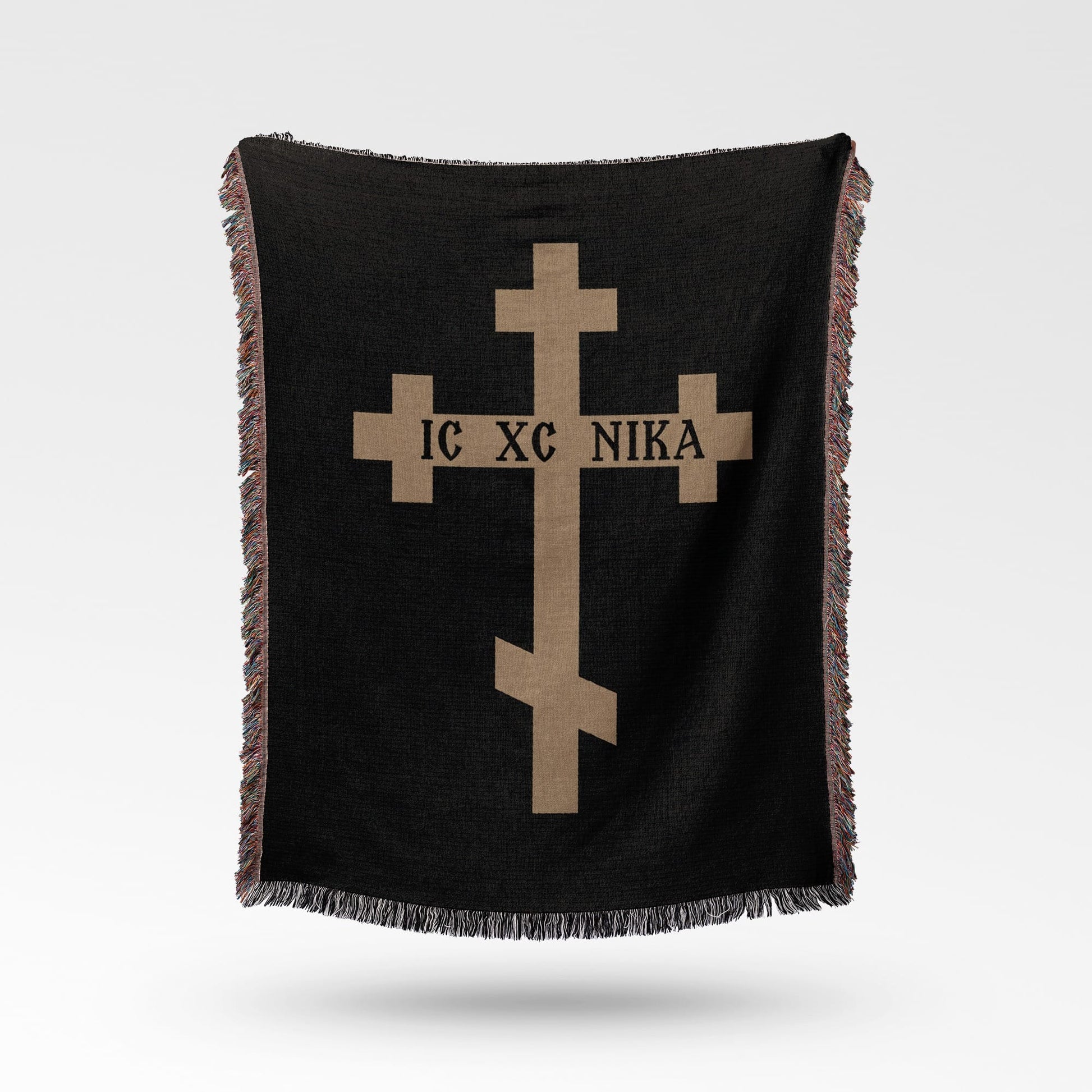 Black blanket with a tan Orthodox cross and text IC XC NIKA.