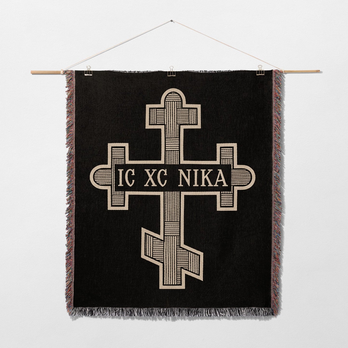 Black tapestry with a gold Byzantine cross and "IC XC NIKA" inscription.