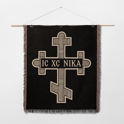 Black tapestry with a gold Byzantine cross and "IC XC NIKA" inscription.