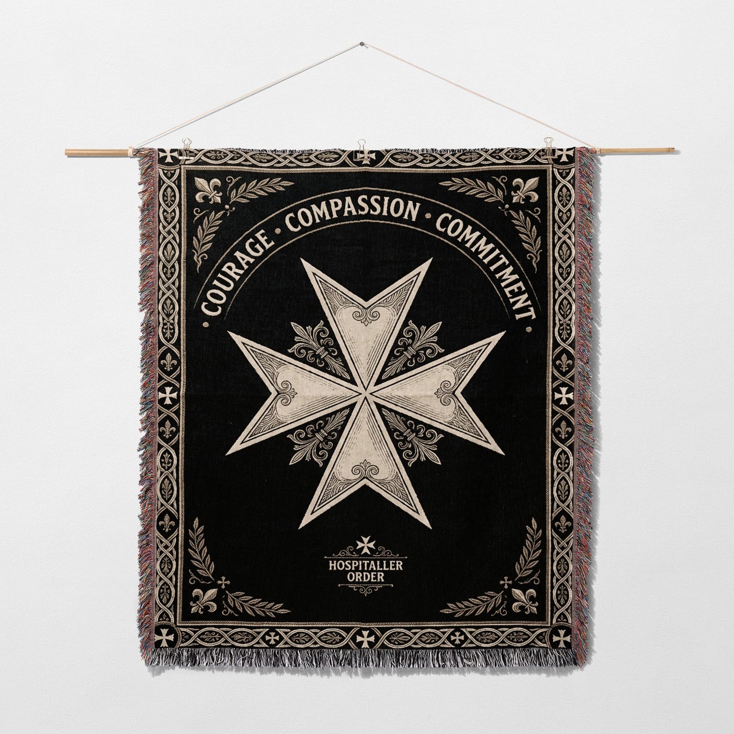 Black woven tapestry with a white Maltese cross and inscribed text.