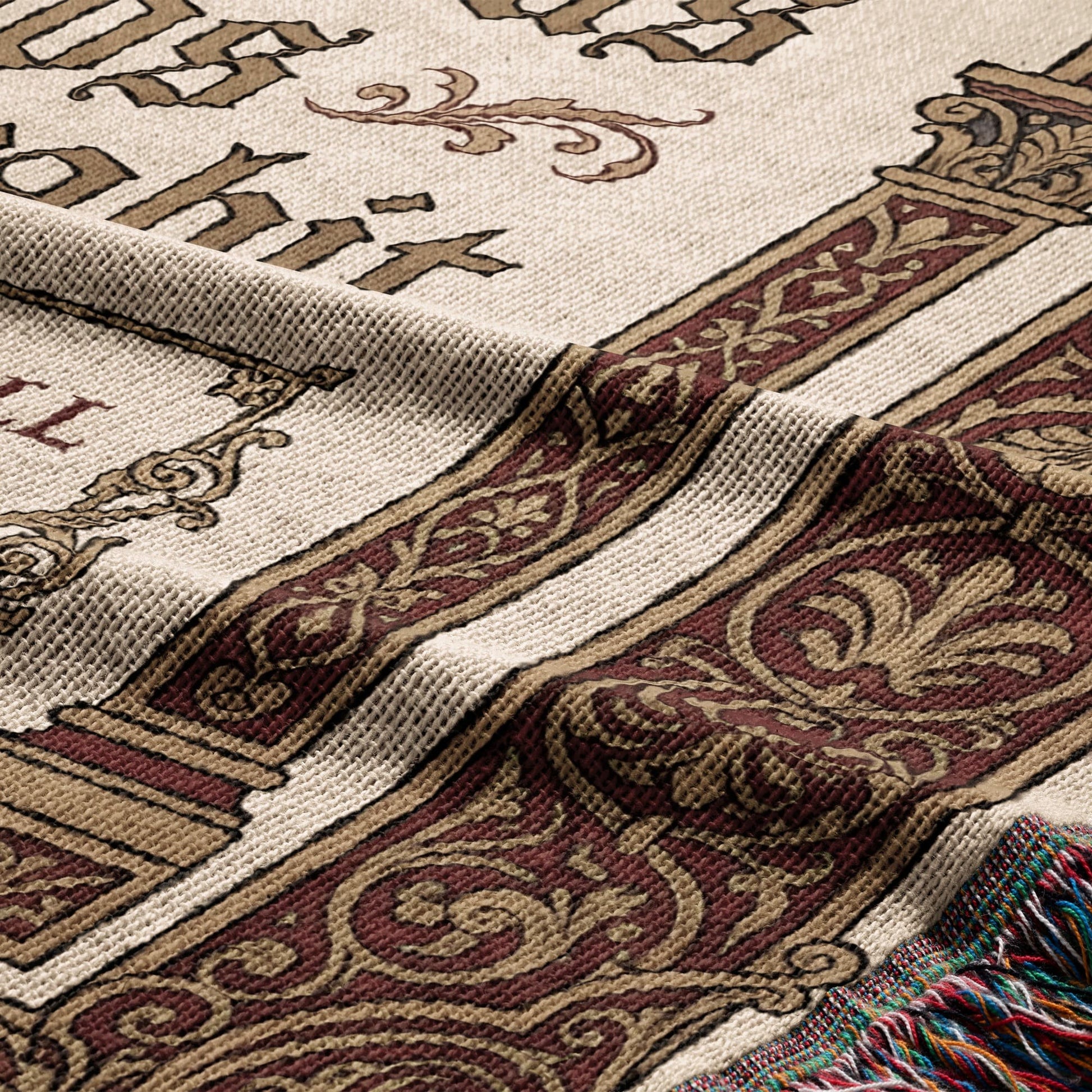 Woven blanket with ornate scrollwork, column motifs, and partial text.