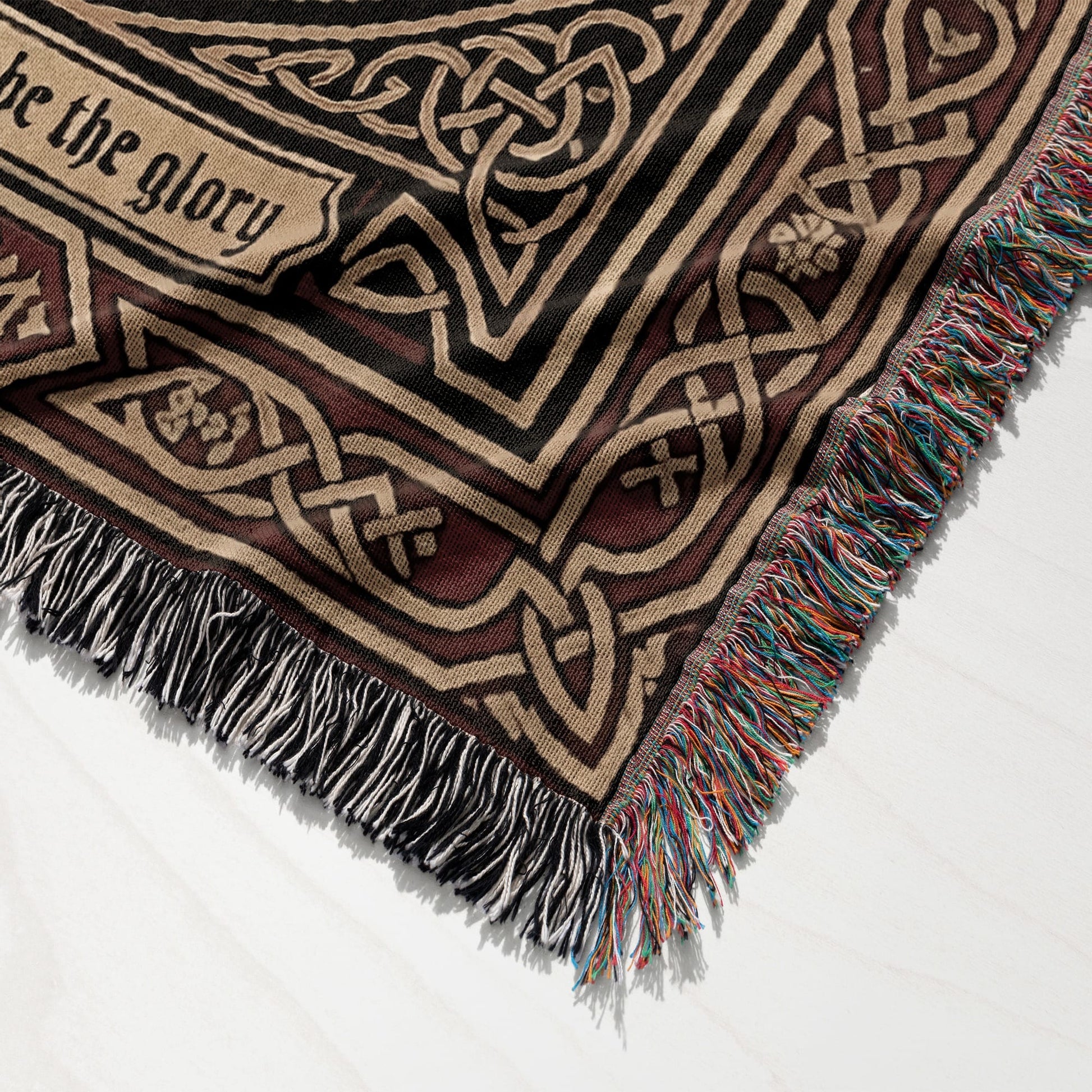 Woven blanket with Celtic knot pattern and fringe, featuring "be the glory".