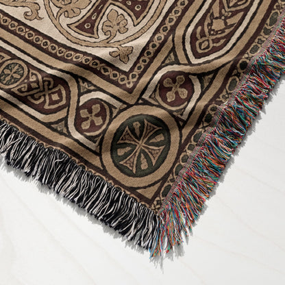 Woven tapestry blanket with fringed edge and intricate geometric pattern.