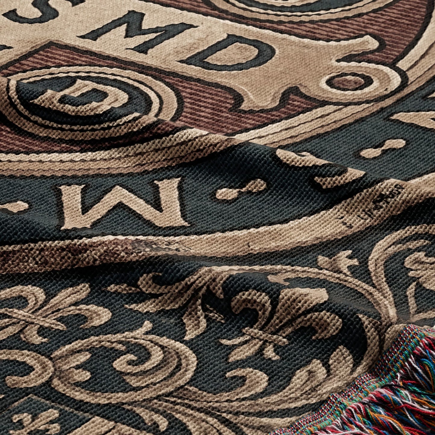 Woven tapestry with ornate scrollwork, fleur-de-lis, and letters.