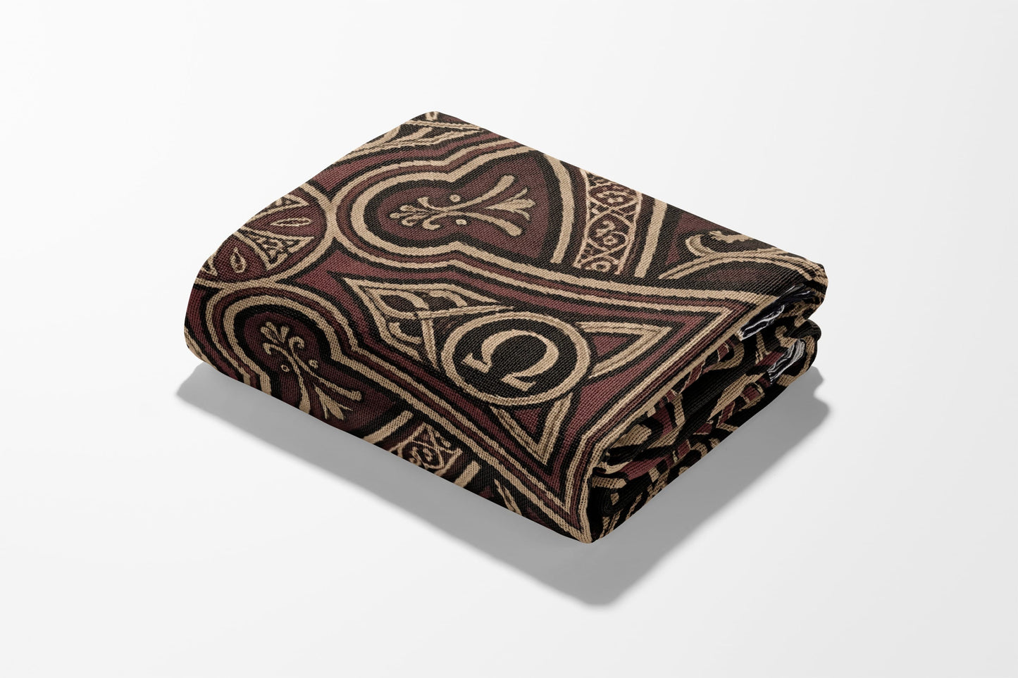 Folded patterned blanket with ornate brown and black Celtic-inspired design.
