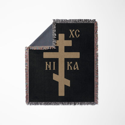 Black throw blanket with a tan Orthodox Christian cross and "XC NI KA".