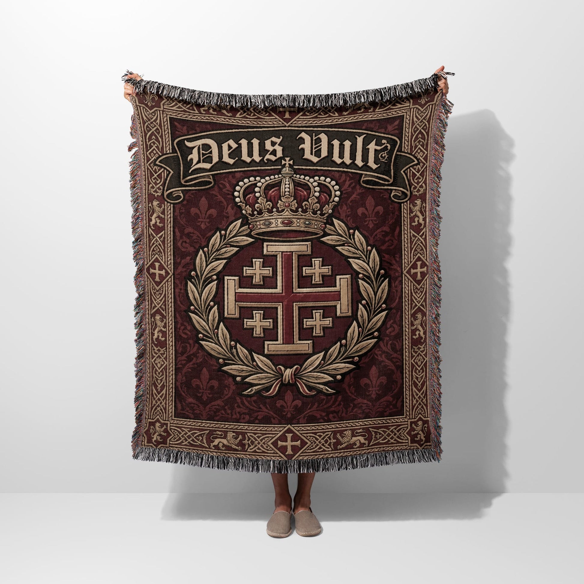Tapestry blanket with "Deus Vult" text, crown, and Jerusalem cross emblem.