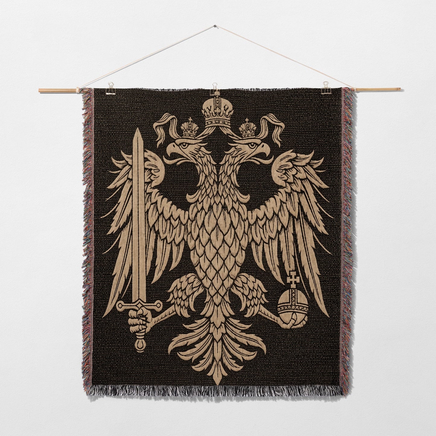 Tapestry featuring the golden double-headed eagle coat of arms on a dark background.