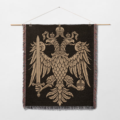 Tapestry featuring the golden double-headed eagle coat of arms on a dark background.