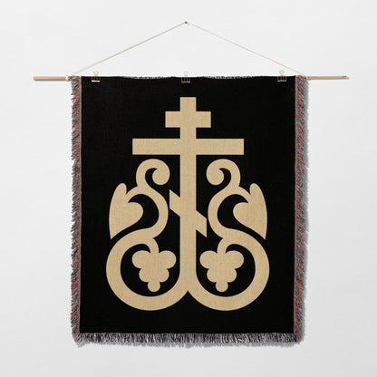 Black woven tapestry with ornate gold cross emblem and decorative flourishes.