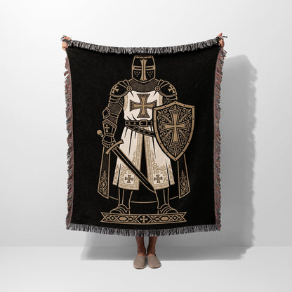 Black blanket with a knight in armor and shield, fringed edges.
