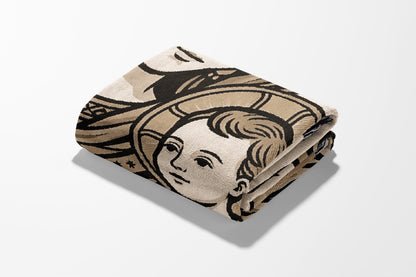 Folded blanket with a stylized depiction of a child's face in brown and beige.