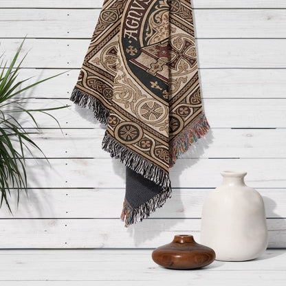 Tapestry with intricate design and fringe hanging on white wooden wall.