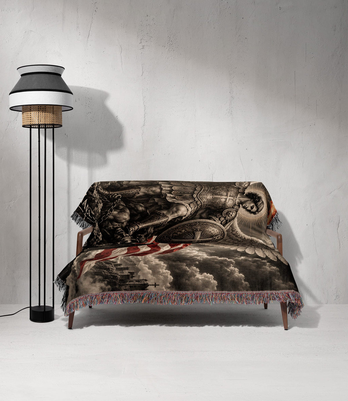 A woven throw blanket featuring a classical angelic battle scene draped over a wooden sofa.