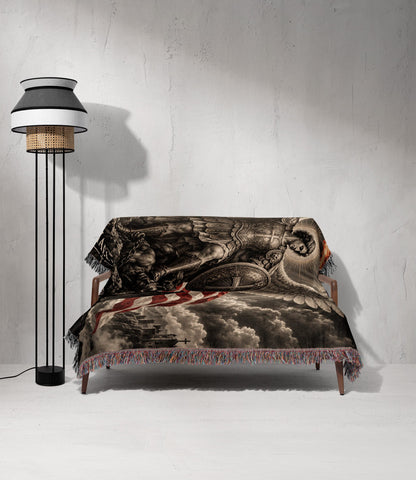 A woven throw blanket featuring a classical angelic battle scene draped over a wooden sofa.