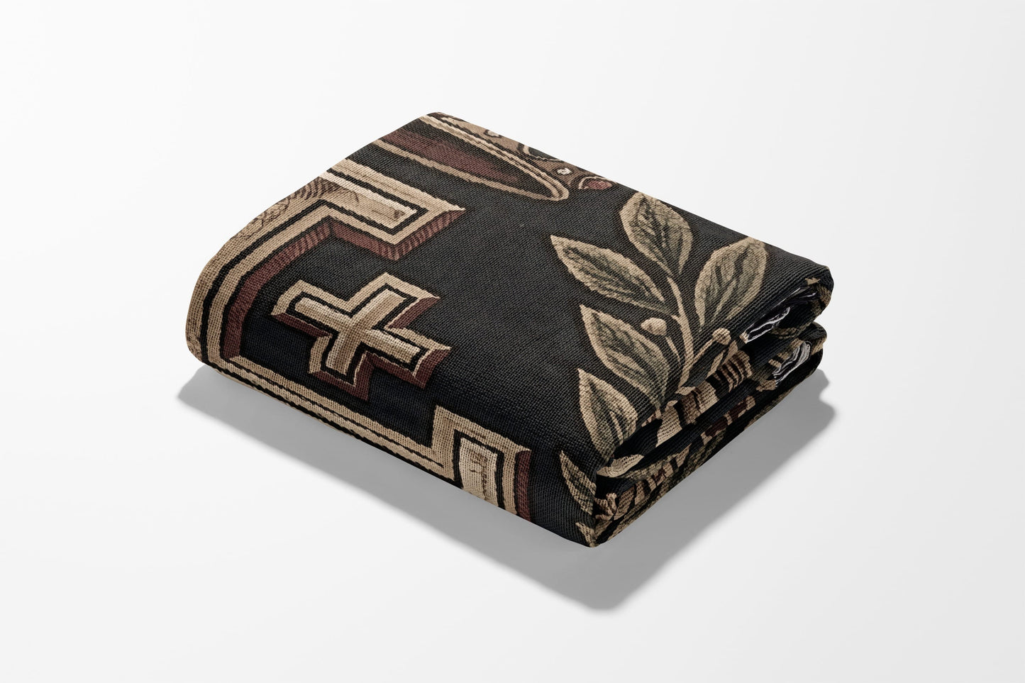 Folded textile with a black background, featuring a cross motif and floral design.