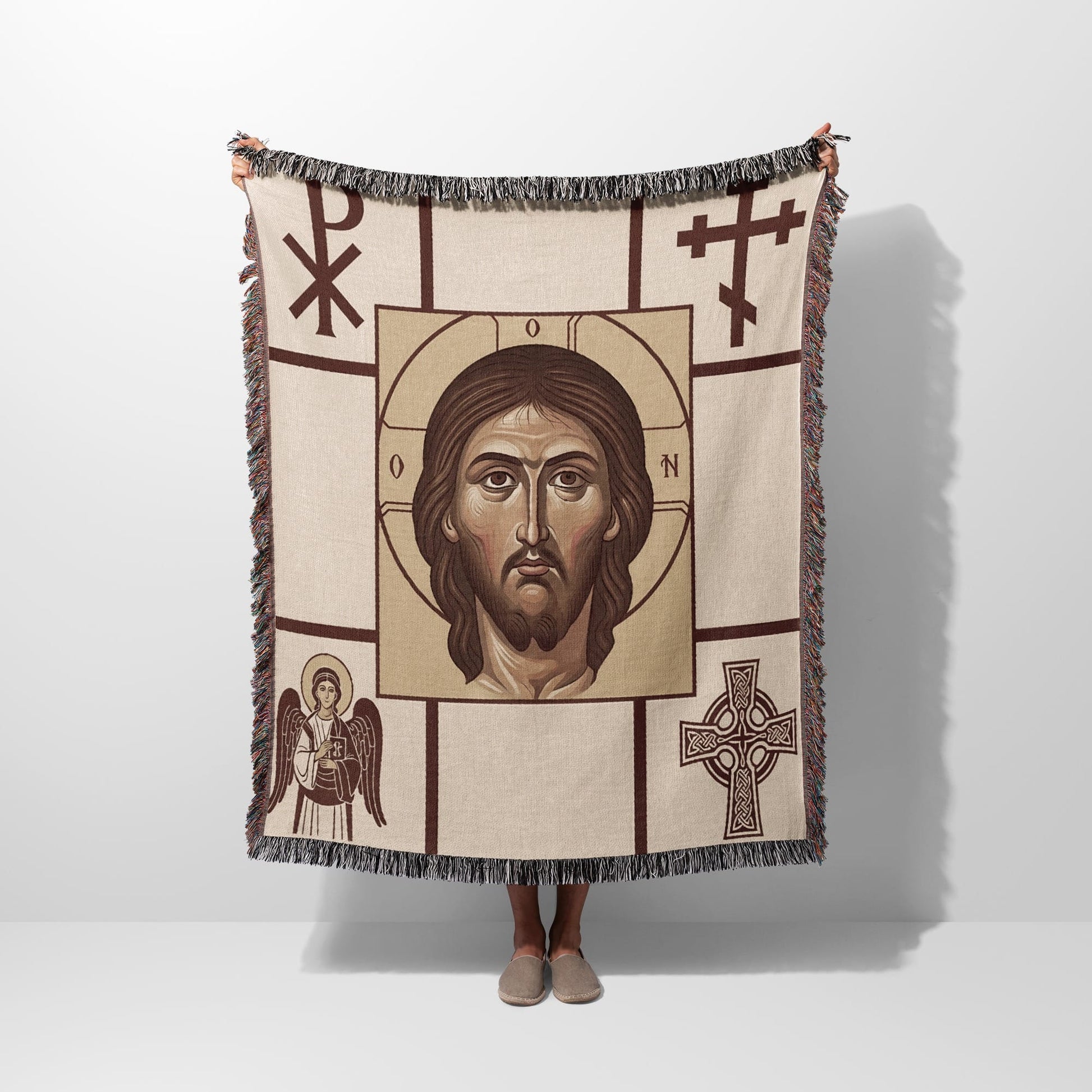 Woven blanket with a central image of Jesus Christ, surrounded by religious symbols.
