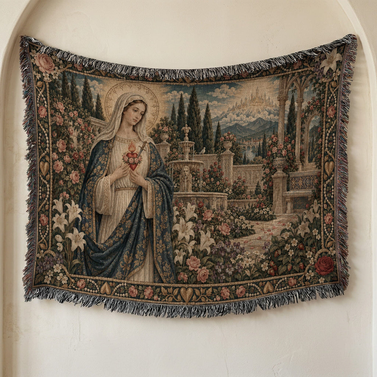A woven throw blanket hangs on a wall, featuring a depiction of the Virgin Mary in a garden.
