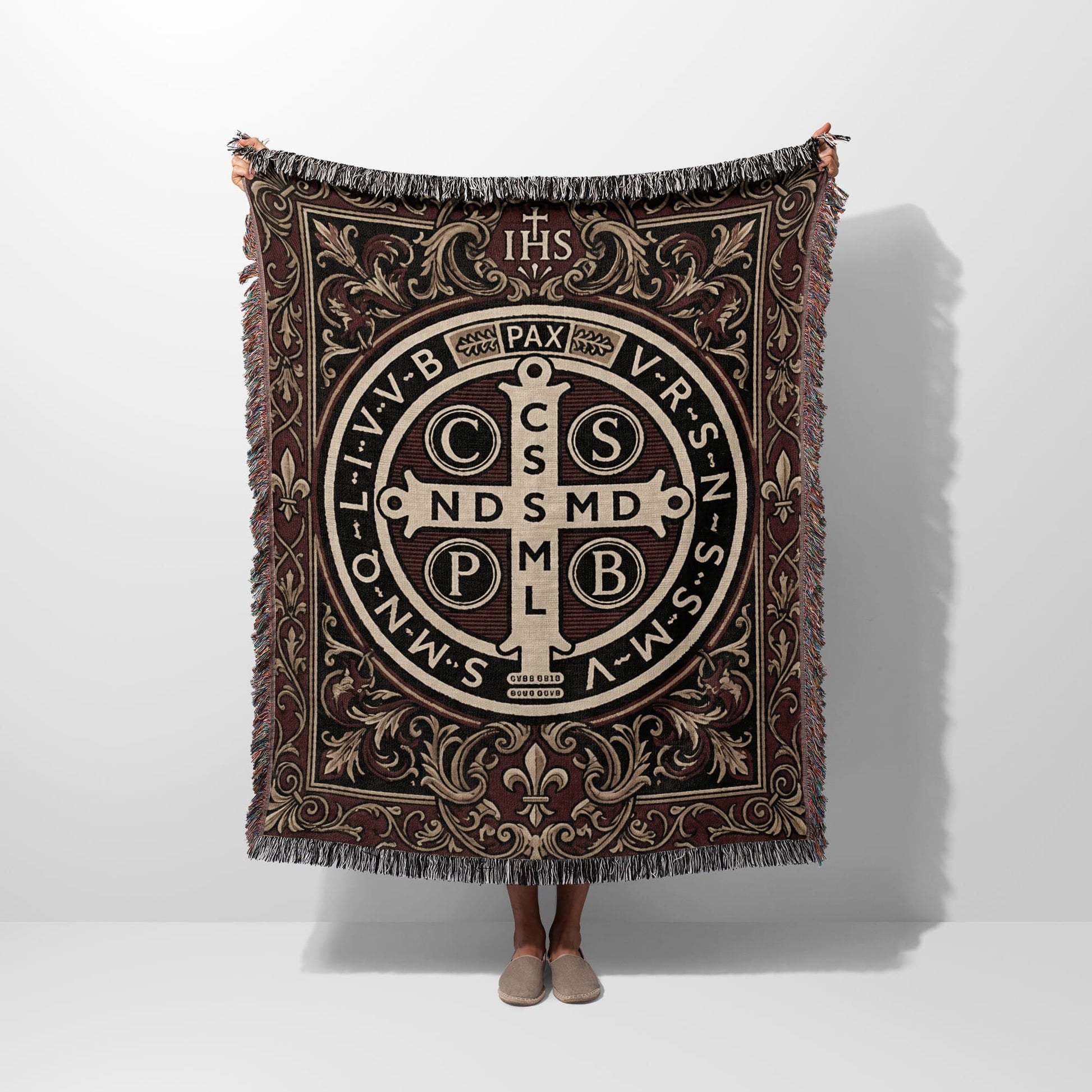Tapestry with St. Benedict's medal, IHS, and PAX text in intricate brown design.