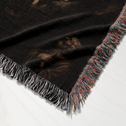 Woven blanket with colorful fringed edge and a dark, classic art print.