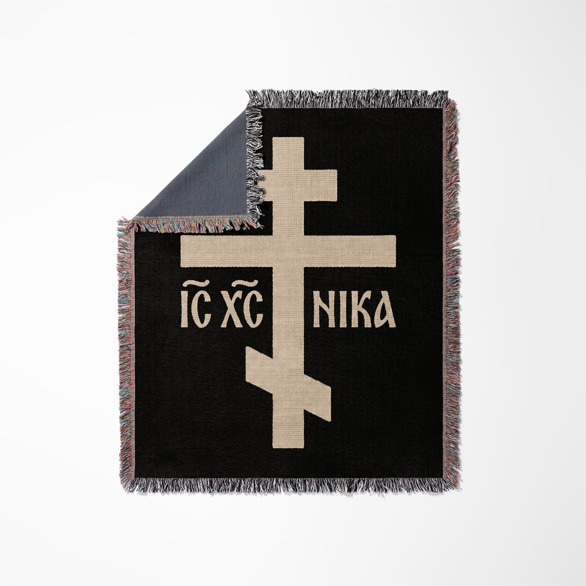 Black throw blanket with tan Greek Orthodox cross and text "IC XC NIKA".