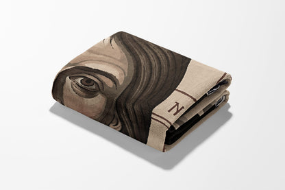 Folded blanket featuring a portrait of a person and "N" graphic.