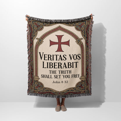 Woven blanket with red cross and "Veritas vos liberabit. The truth shall set you free. John 8:32."