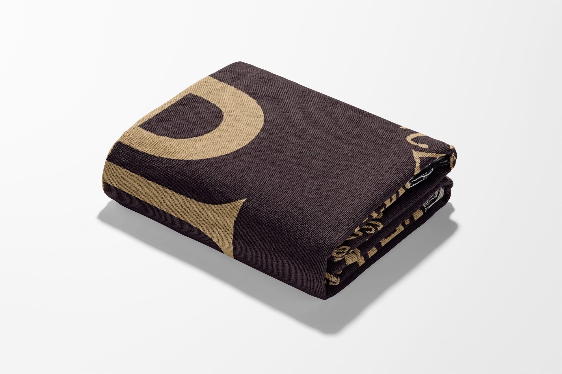 Folded brown blanket with a large tan "D" pattern, on a white background.