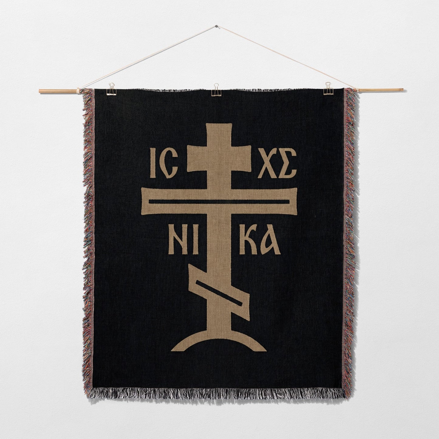 Black tapestry with gold Orthodox Christian cross and inscription IC XC NIKA.